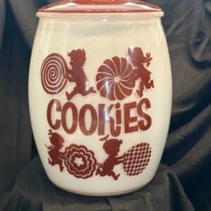 A cookie jar with cookies written on it.
