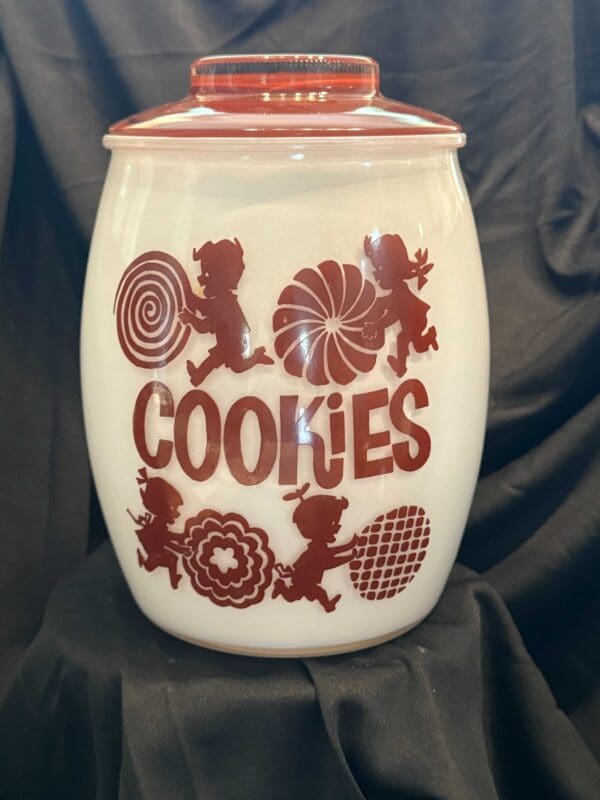 A cookie jar with cookies written on it.