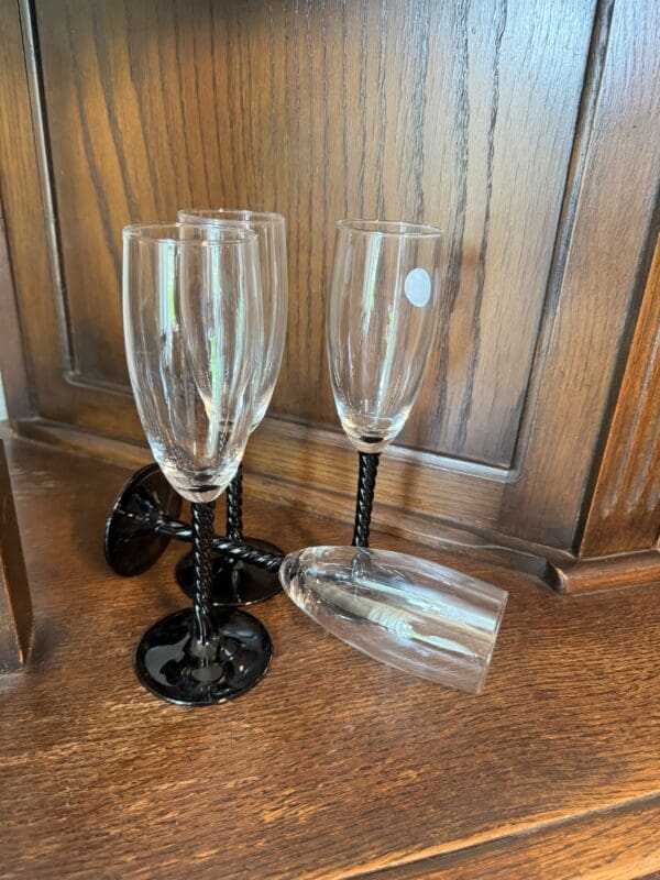 A group of wine glasses sitting on top of the floor.