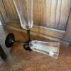 A glass of wine is sitting on the floor.