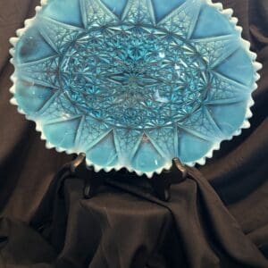 A blue glass bowl sitting on top of a table.