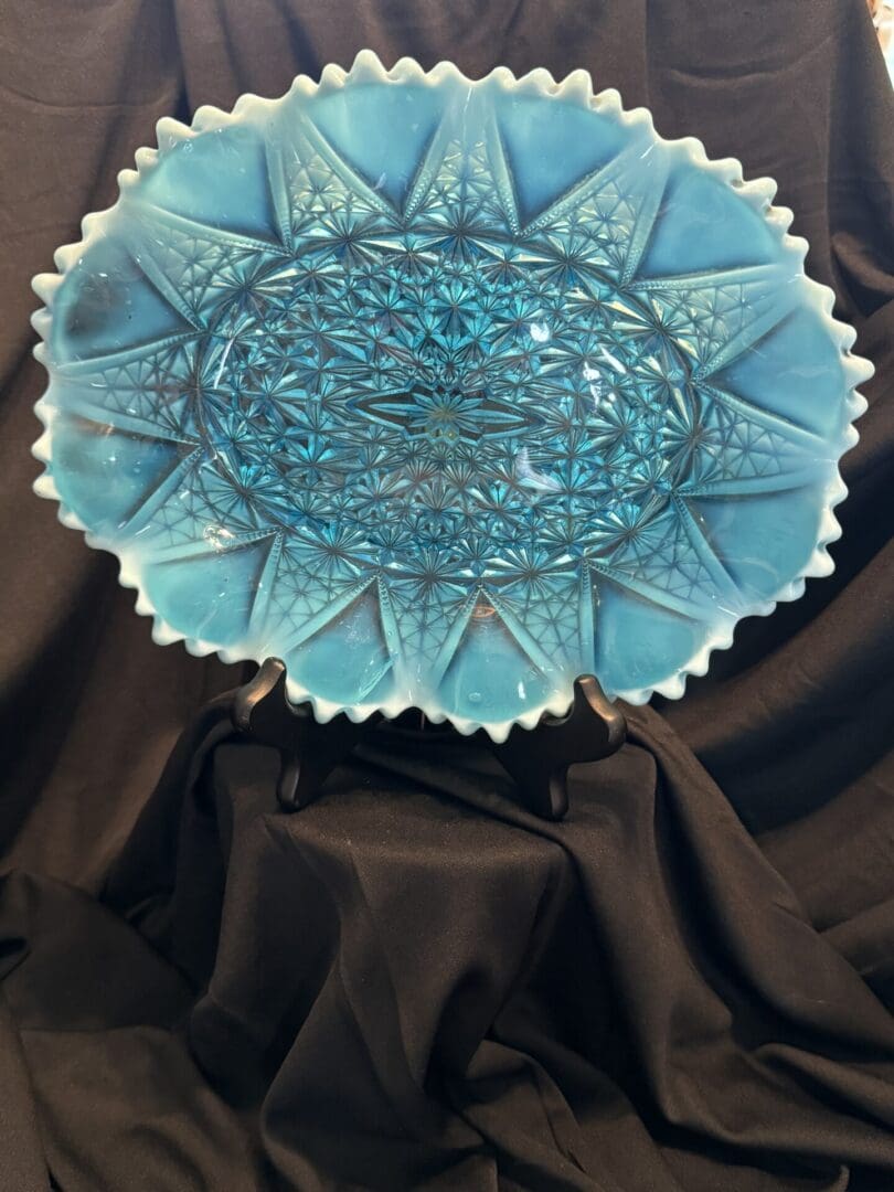 A blue glass bowl sitting on top of a table.