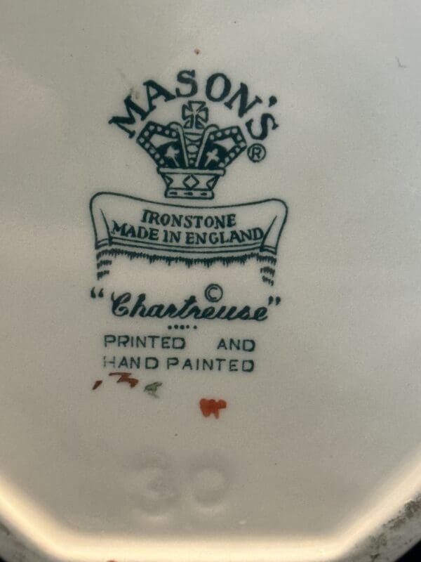 A close up of the back of a plate with a crown on it