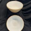 Two bowls are sitting on a black cloth.
