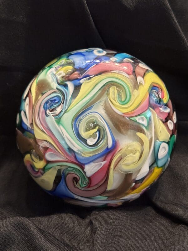 A ball with swirls of colors on it