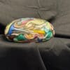 A close up of a colorful object on top of a black cloth.