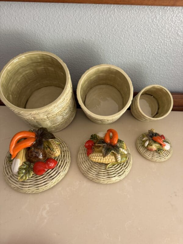 A group of four containers with vegetables on them.