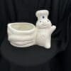 A white ceramic bunny planter sitting on top of a table.