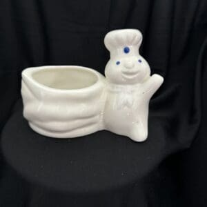 A white ceramic bunny planter sitting on top of a table.