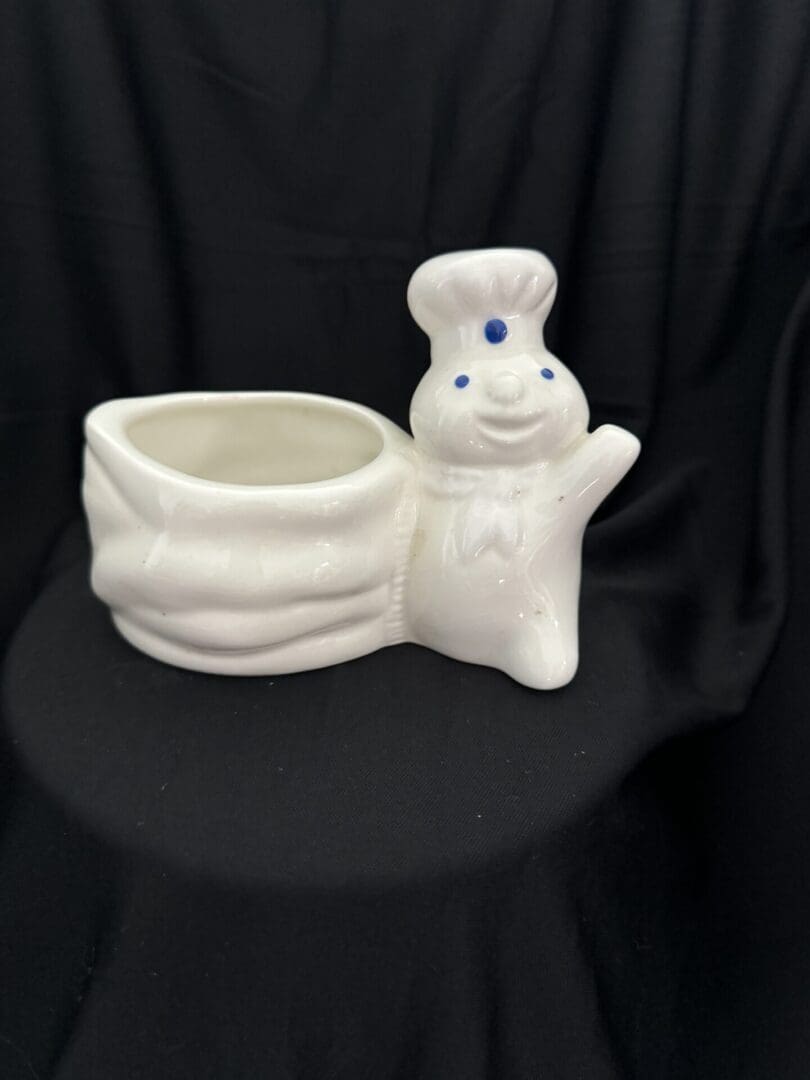 A white ceramic bunny planter sitting on top of a table.