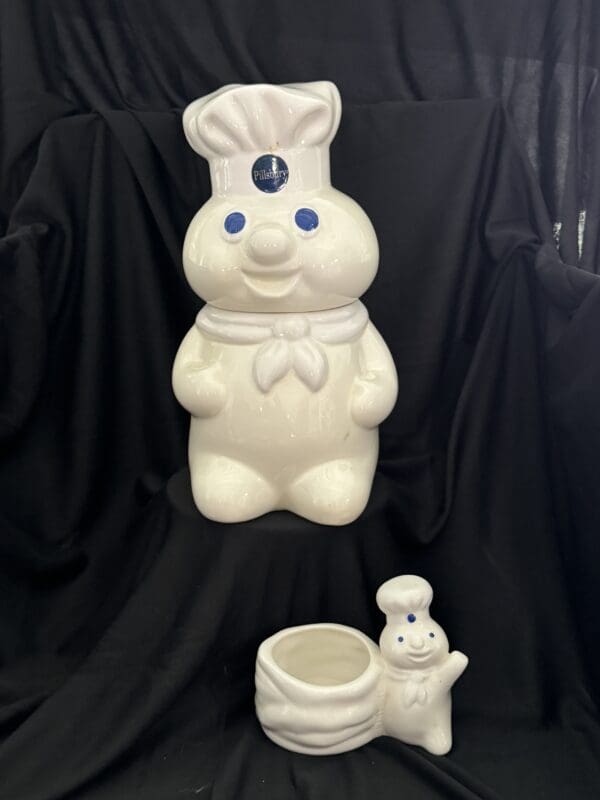 A white bunny with a chef hat on and a cup.