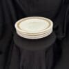 A stack of three plates on top of black cloth.