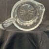 A glass pitcher sitting on top of a table.