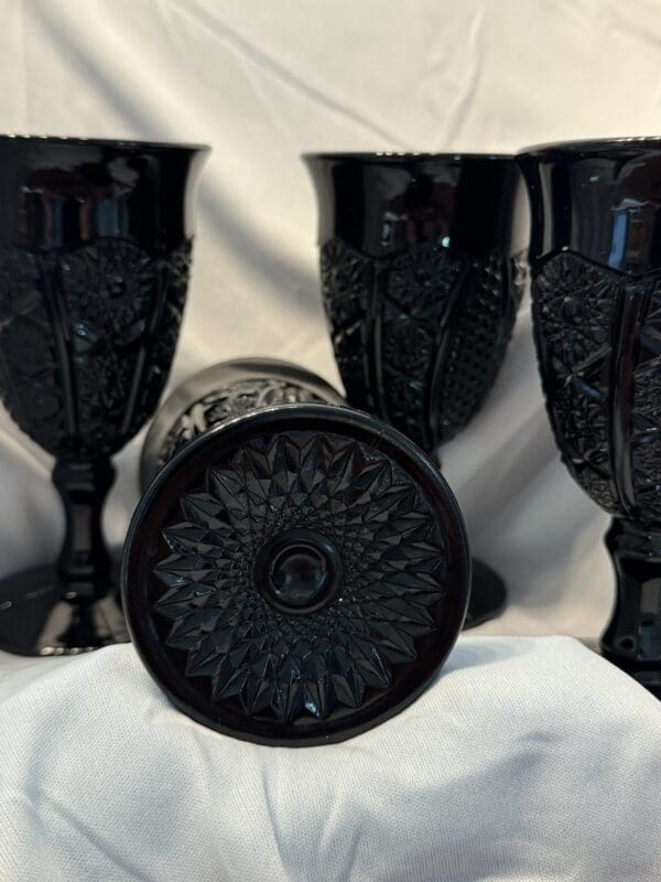 A group of black cups sitting on top of a table.