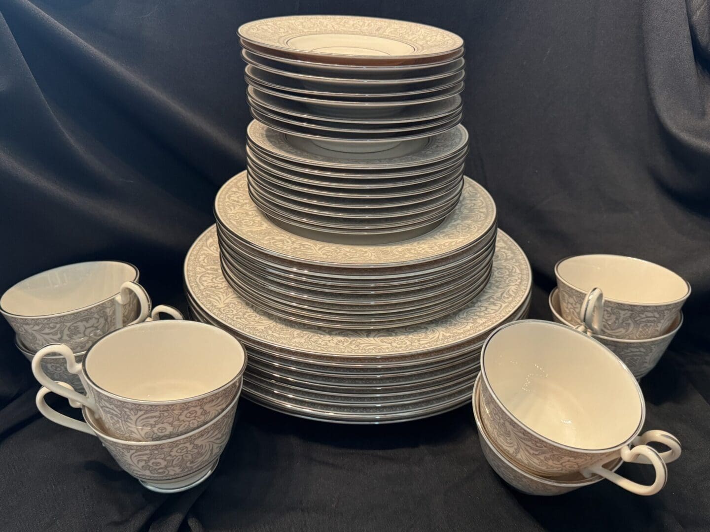 A stack of plates and cups on top of each other.