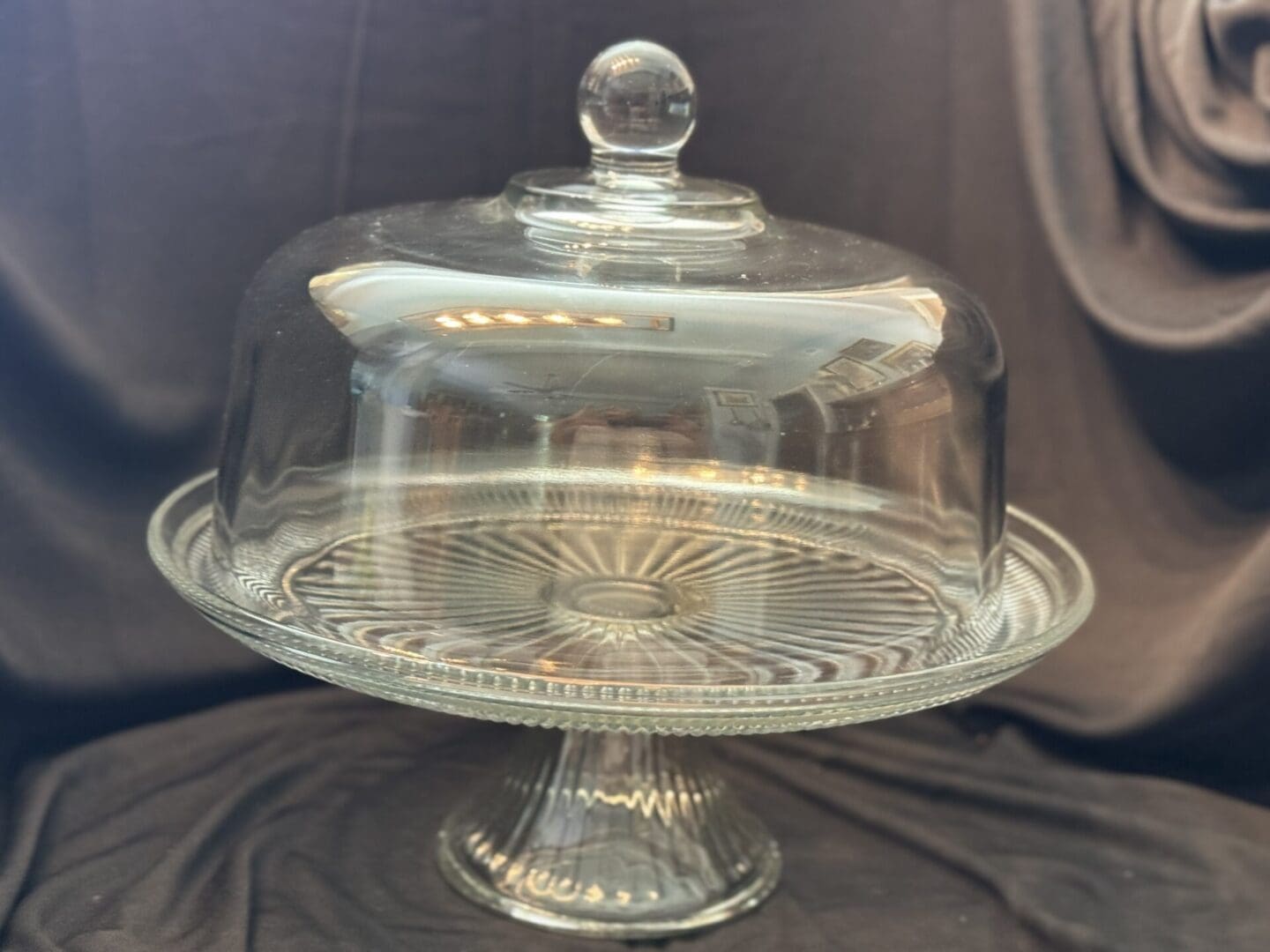 A glass cake plate with a dome lid.