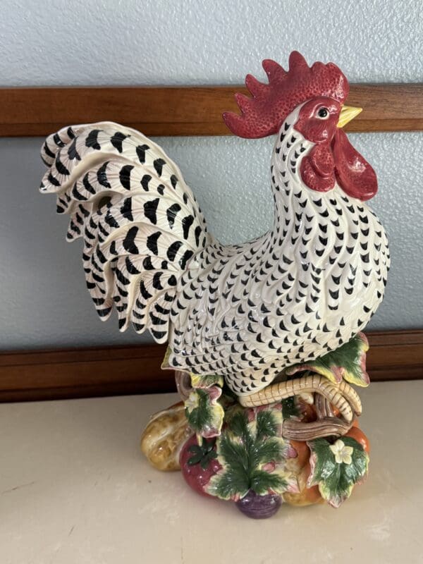 A black and white rooster statue sitting on top of a table.