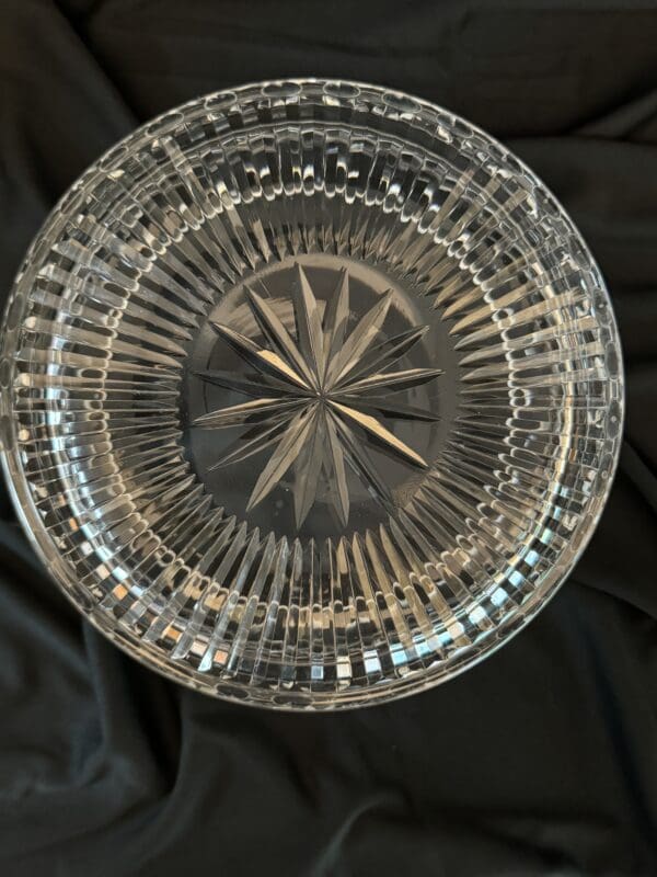 A glass bowl sitting on top of a bed.