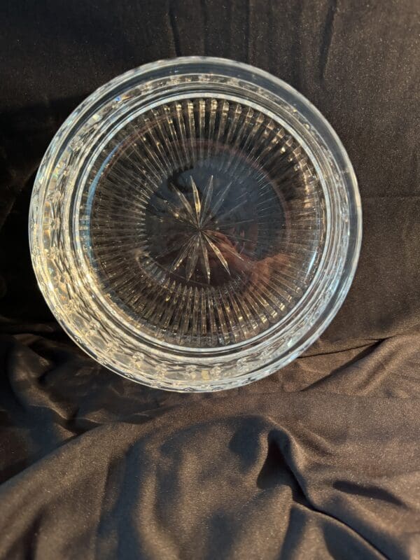 A glass bowl sitting on top of a brown cloth.