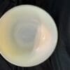 A white bowl sitting on top of a table.