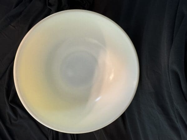 A white bowl sitting on top of a table.