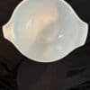 A white bowl sitting on top of a table.