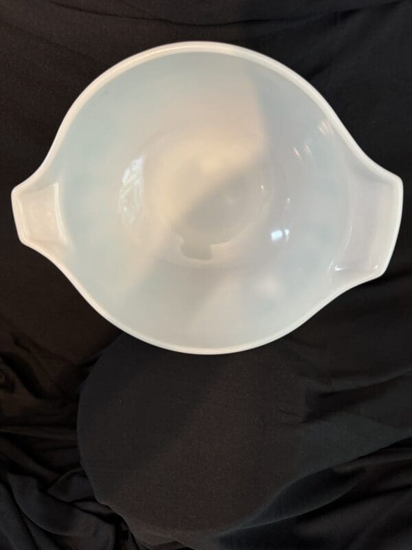 A white bowl sitting on top of a table.