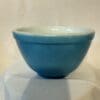 A blue bowl sitting on top of a table.