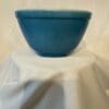 A blue bowl sitting on top of a white table.