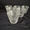 A set of six glasses sitting on top of a table.
