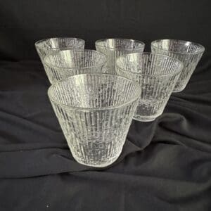 A set of six glasses sitting on top of a table.
