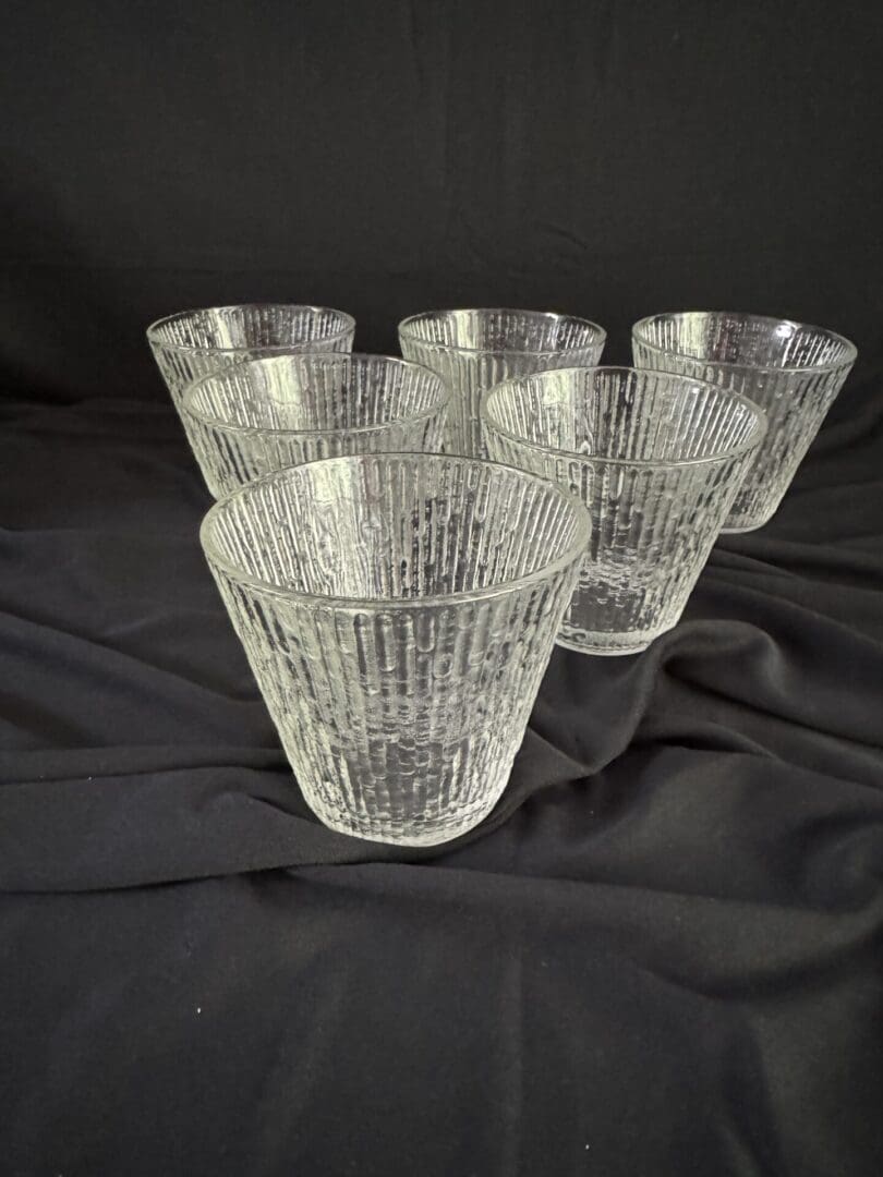 A set of six glasses sitting on top of a table.