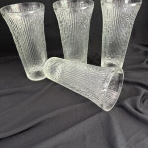 A group of four glasses sitting on top of a table.