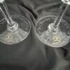 Two wine glasses sitting on top of a table.