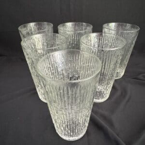 A group of six glasses sitting on top of a table.