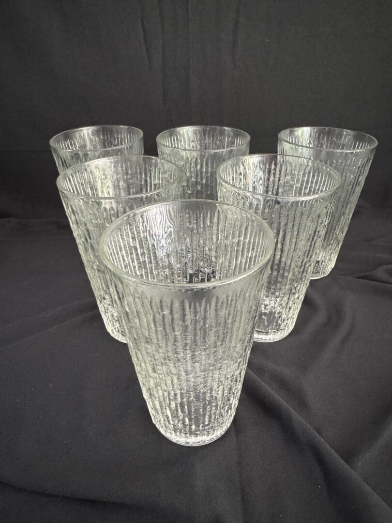 A group of six glasses sitting on top of a table.