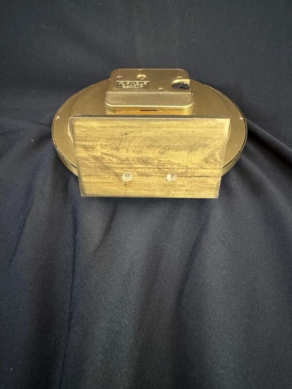 A gold box sitting on top of a black cloth.