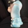 A blue and white smurf figurine sitting on top of a table.