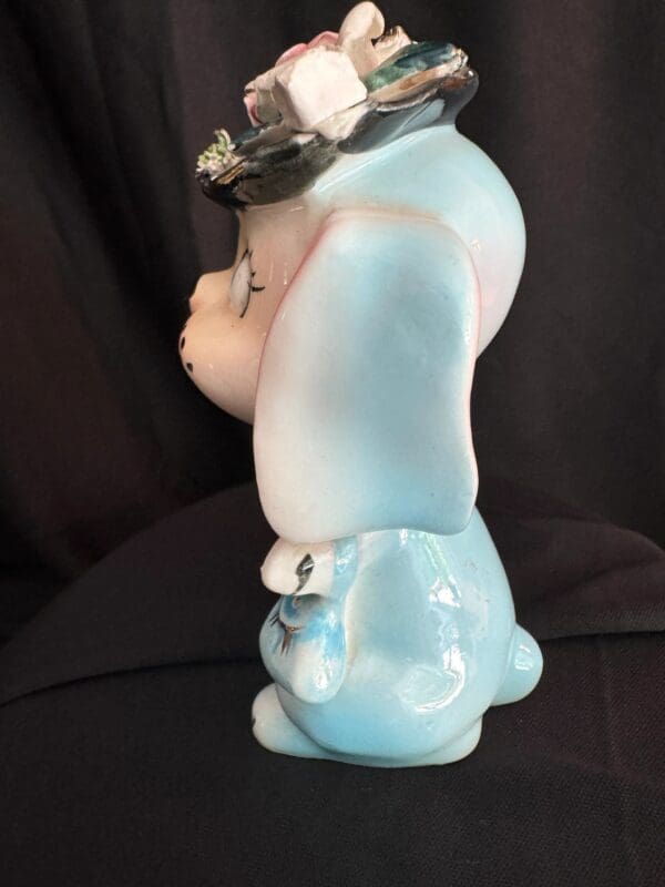 A blue and white smurf figurine sitting on top of a table.