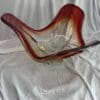 A glass bowl sitting on top of a white cloth.