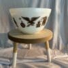 A bowl sitting on top of a wooden stool.