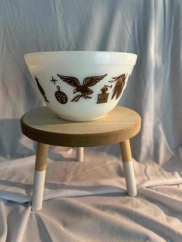 A bowl sitting on top of a wooden stool.