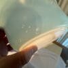 A person holding onto a container with water on it
