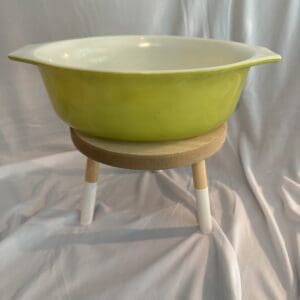 A bowl on a stand is shown in front of a white background.