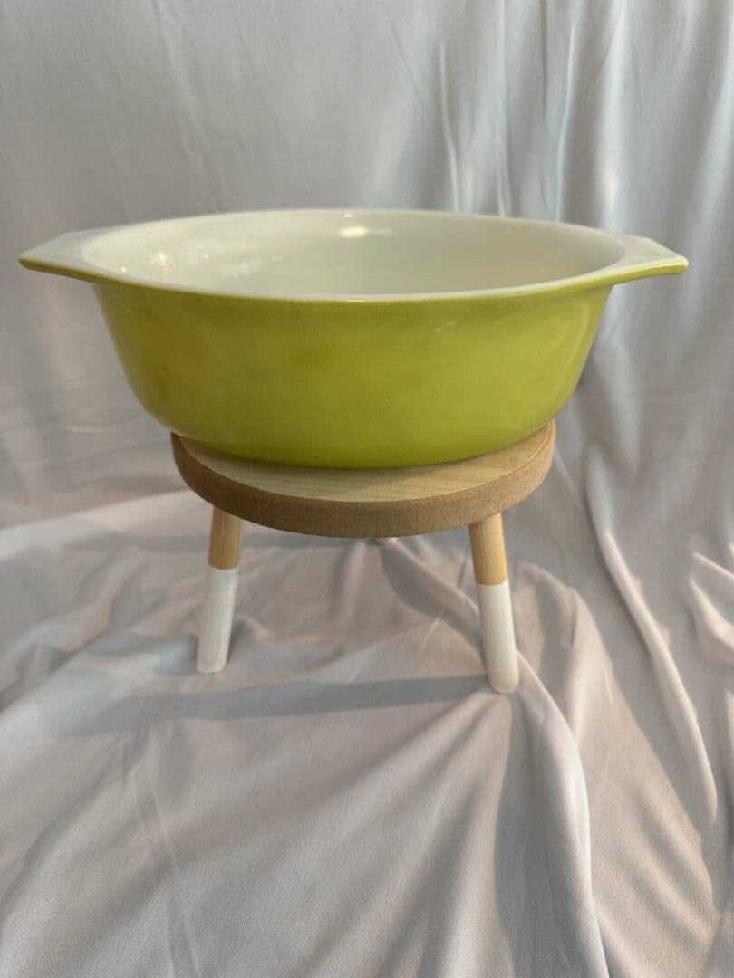 A bowl on a stand is shown in front of a white background.