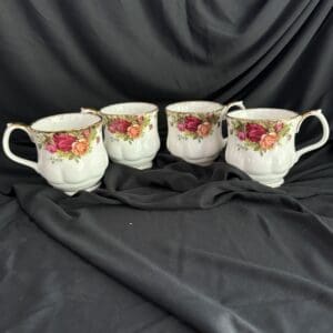 Four cups with a floral design on them.