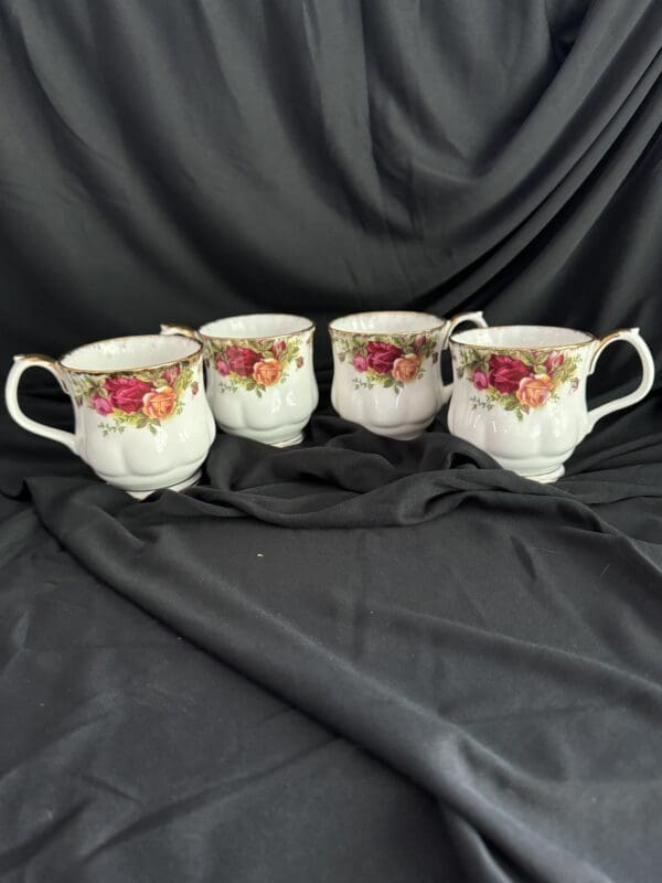 Four cups with a floral design on them.