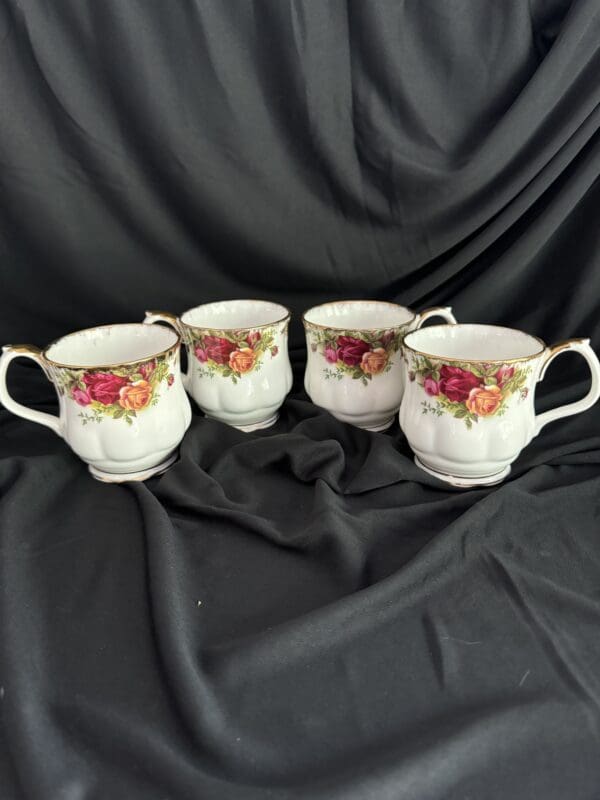 Four cups with a floral design on them.