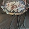 A silver tray with flowers on it