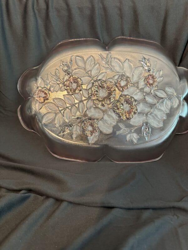 A large glass dish with flowers on it